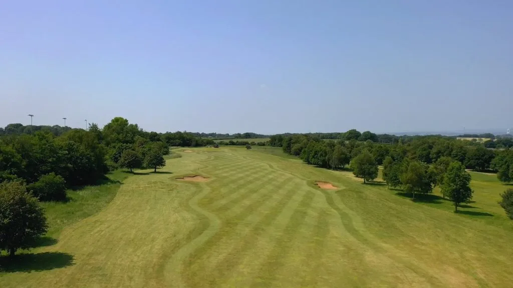 Aerial view of a well-cut fairway at a golf course in Bristol.