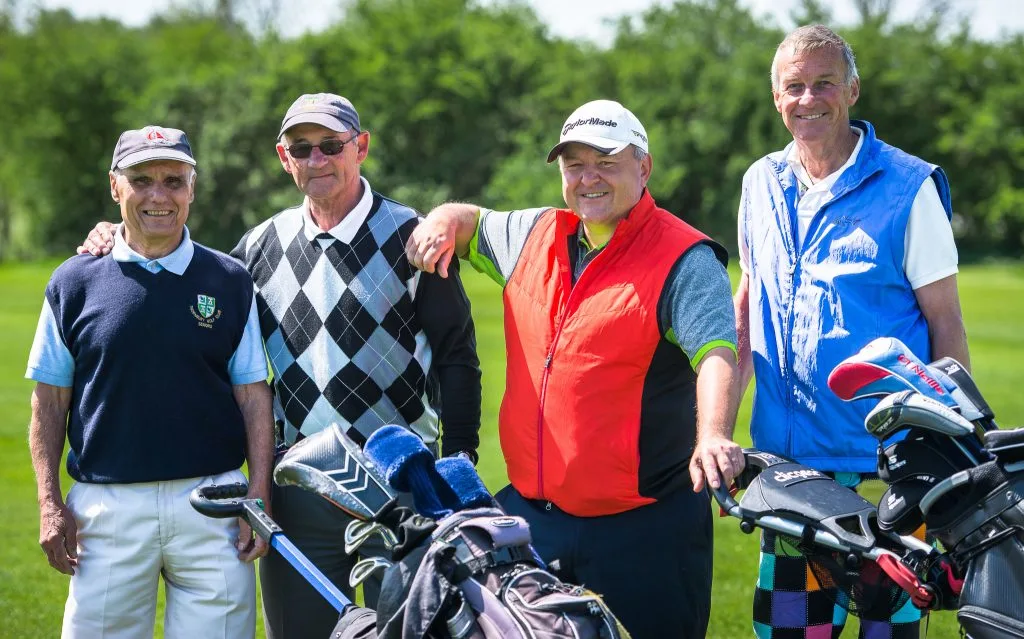 group of senior men smiling at a golf day in bristol