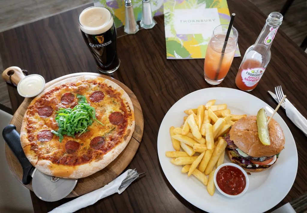 Two plates served with pizza and a burger at a restaurant in Bristol.