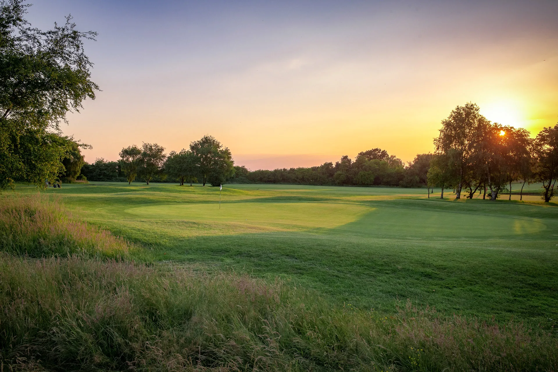 sun setting over golf course in bristol