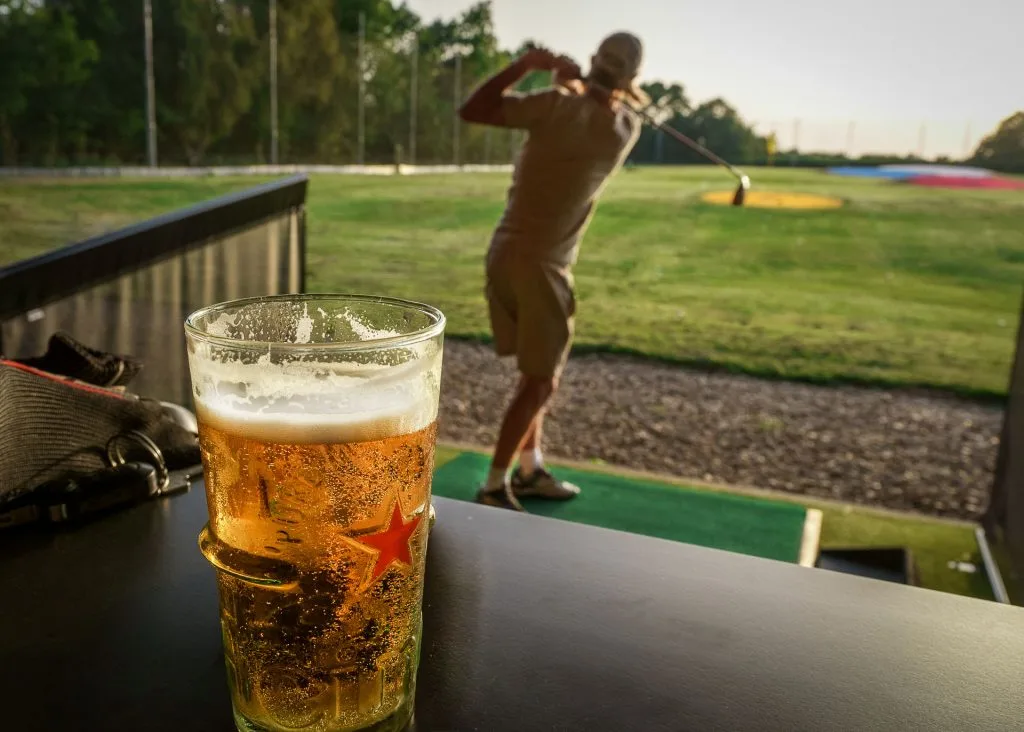 a pint of beer on a driving range bay table in bristol