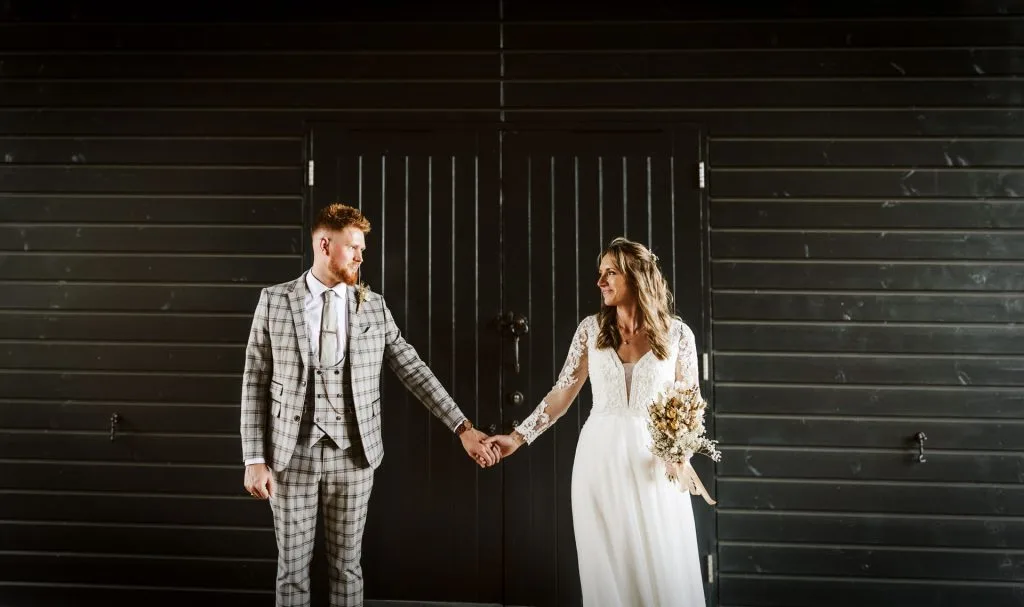 married couple holding hands gazing into each other eyes at wedding venue in bristol