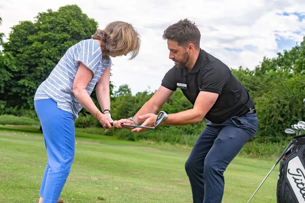 woman getting a golf lesson in bristol