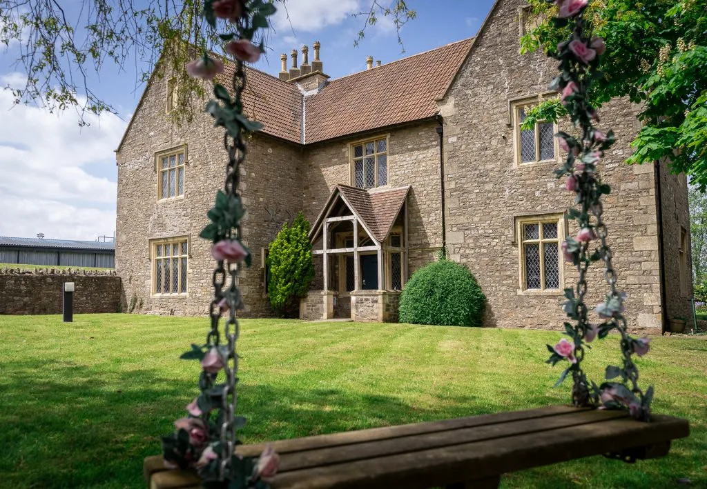 Relaxing outdoor swing at The Lodge, a stay and play golf hotel near Bristol in the village of Alveston