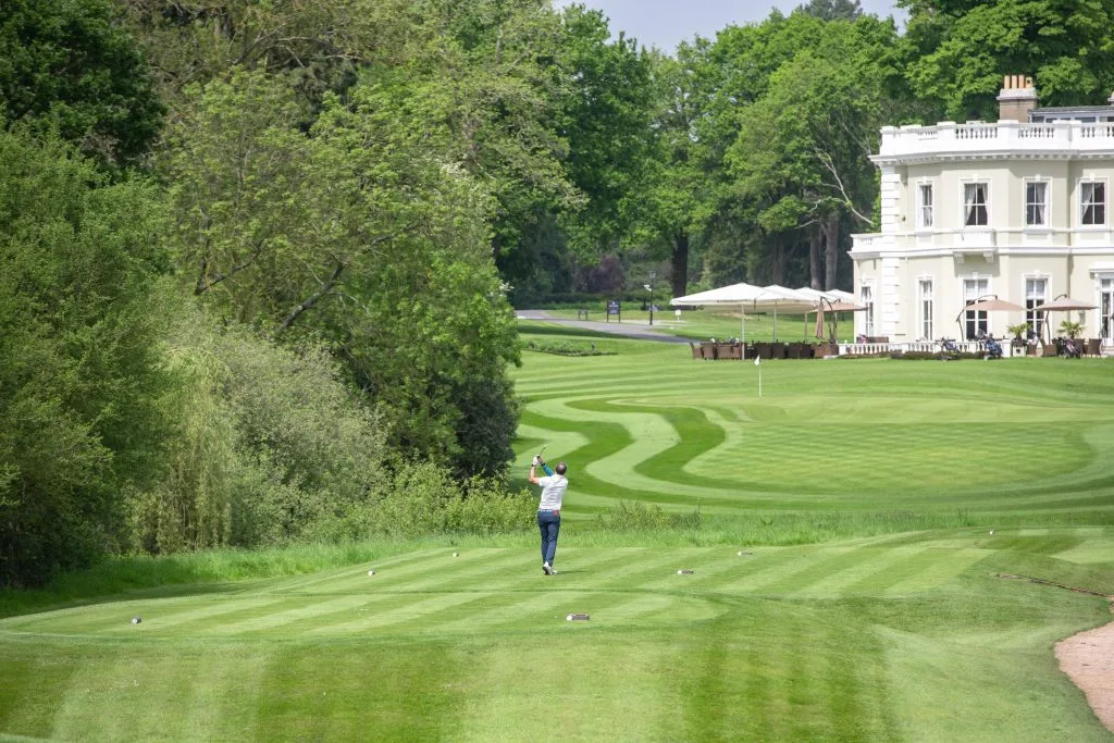 man hitting golf ball after purchsing golf membership in bristol