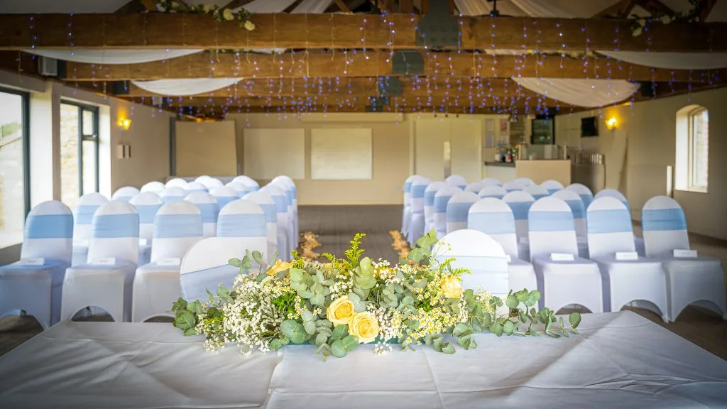 Top table decorated with fresh flowers at Thornbury Golf and Lodge, a beautiful wedding venue near Bristol