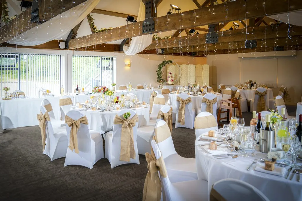 Beautifully decorated wedding reception with tables and fairy lights at Thornbury Golf and Lodge, a charming venue for weddings near Bristol
