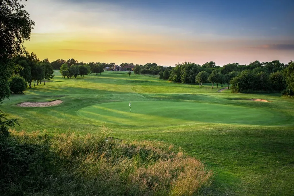 sun rays on golf hole in bristol