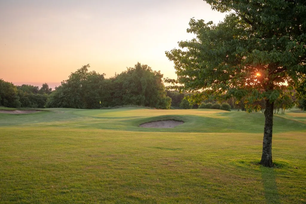 golf green with sun setting at golf course in bristol